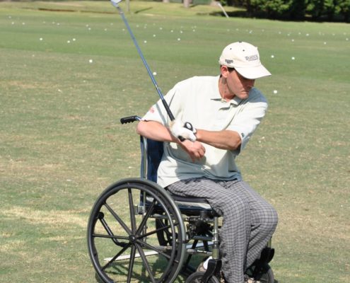 man golfing from a wheelchair