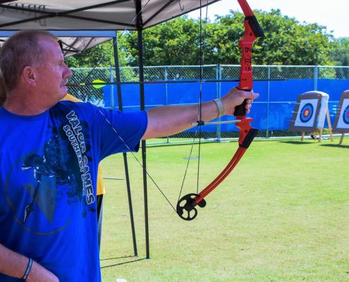 Valor Games Southeast Athlete using mouth tab to pull back bow