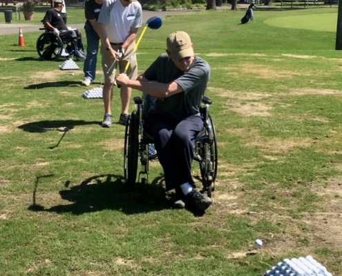 several people with different disabilites golfing
