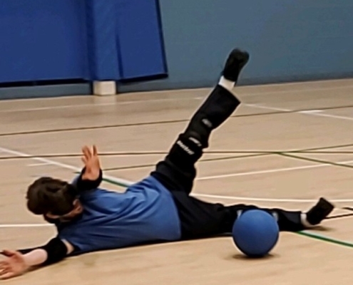 goalball athlete outstretched blocking ball